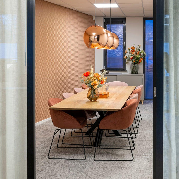 Moderne vergaderruimte met design vergadertafel, comfortabele stoelen en koperen lampen