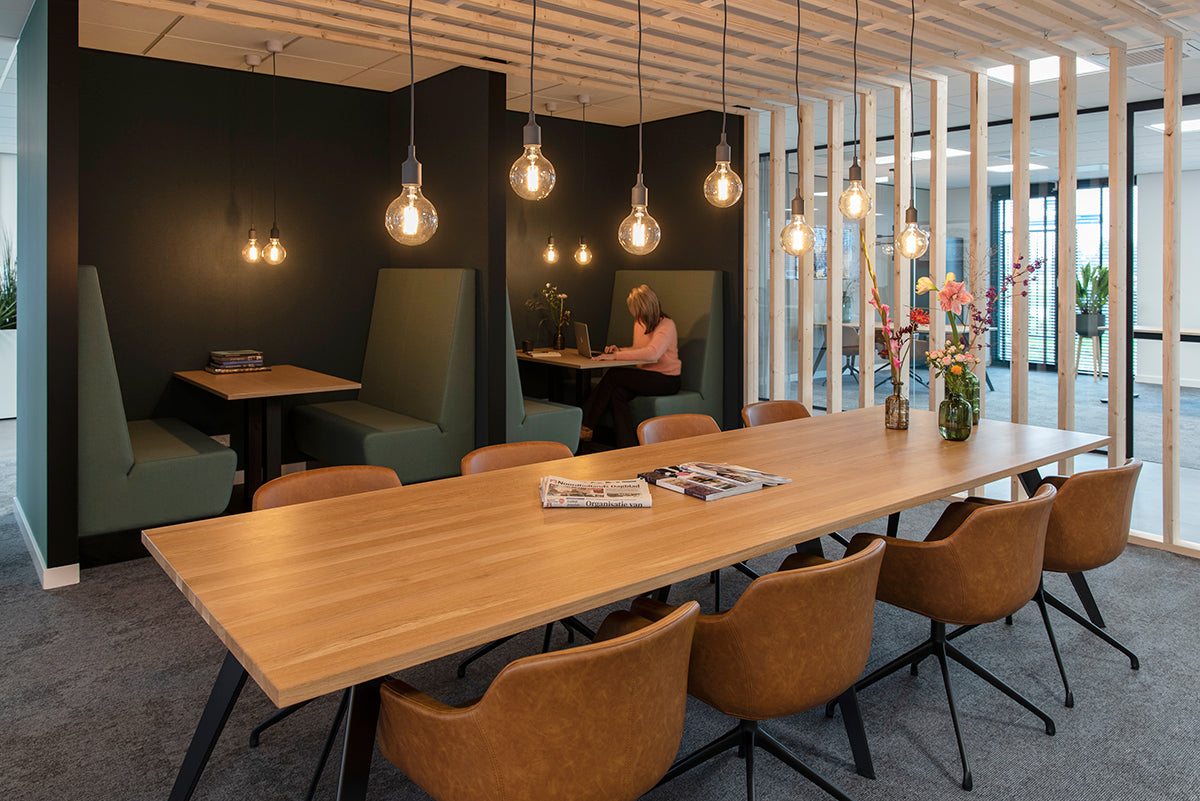 Moderne kantoorruimte met design kantoormeubels, vergadertafel, leren stoelen en sfeerverlichting