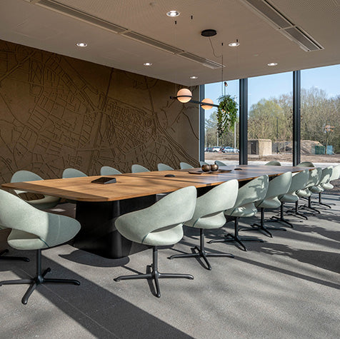 Moderne vergaderruimte met design vergadertafel en comfortabele bureaustoelen, natuurlijk licht