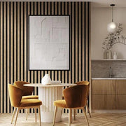 Design kantoorruimte met akoestische pet-vilt lattenwand, ronde tafel en gele stoelen