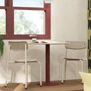Moderne clubtafel met twee design stoelen in lichte kantoorruimte bij raam, ideaal kantoormeubilair.