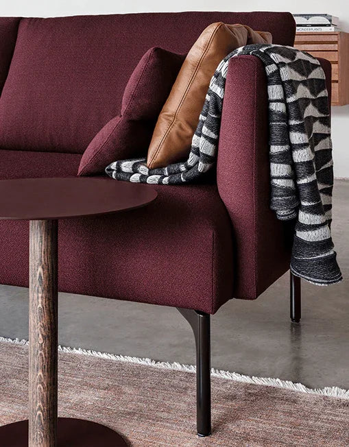 Designbank Artifort Arris bordeauxrood in moderne kantoorruimte met plaid en kussen