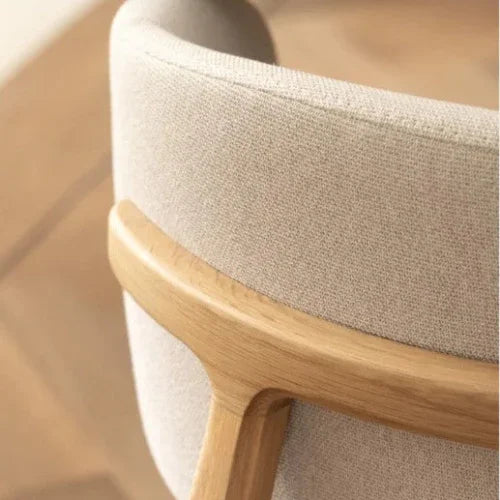 Detail van een moderne bureaustoel met houten frame en beige bekleding, kantoormeubels
