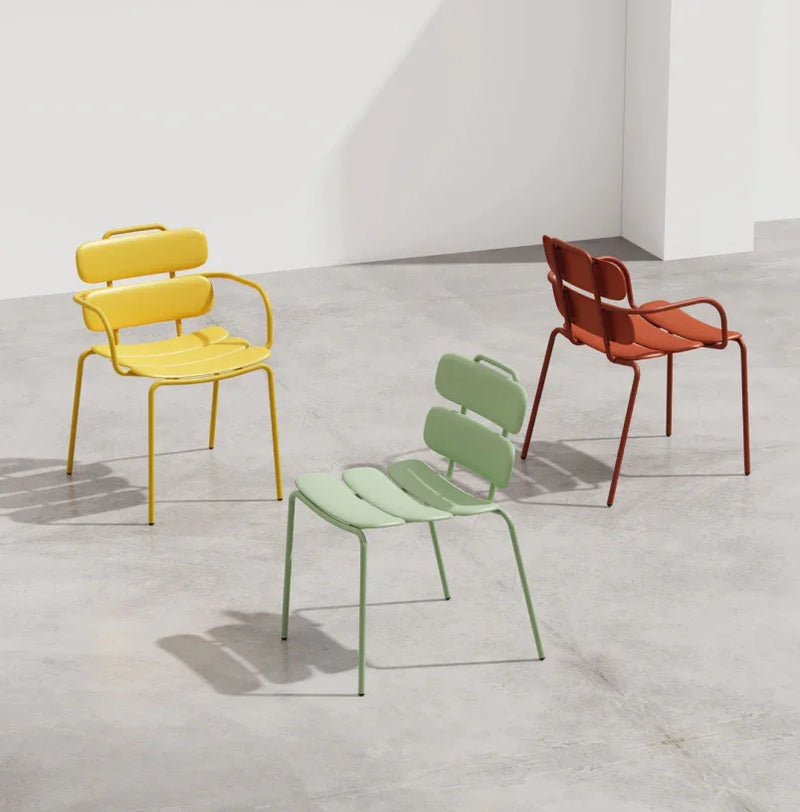 Design limona stapelbare terrasstoelen in geel, groen en rood op betonnen vloer