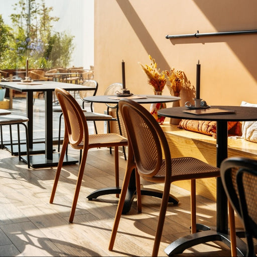Pedrali Remind terracotta stoelen op een terras, gecombineerd met kolomtafels